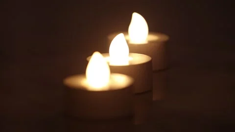 Three burning e-candles in a line with dark background Stock Footage 146536333