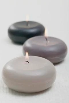 Three burning floating candles Foto stock