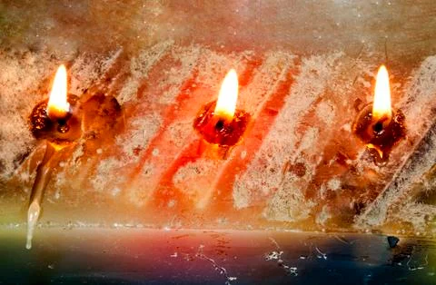 Three burning wicks on large rectangular candle Stock Photos