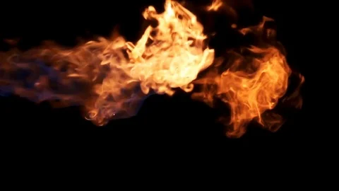 Three bursts of flame shot in slow motion against black Stock Footage 77134558