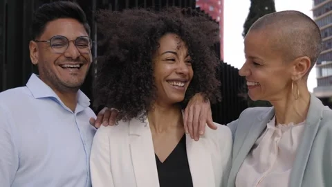 Three business colleagues pose looking at camera smiling outdoor. Positive Stock Footage 251465846