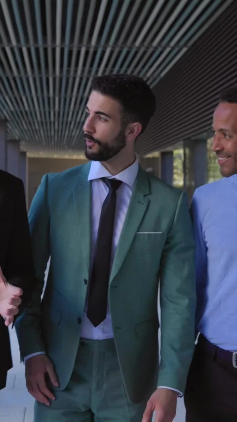 Three business colleagues talking while walking outside an office area Stock Footage 312263950