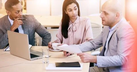 Three business executives communicating during meeting in conference room Stock-Fotos
