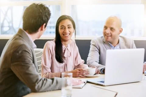 Three business executives communicating during meeting in conference room Stock Photos