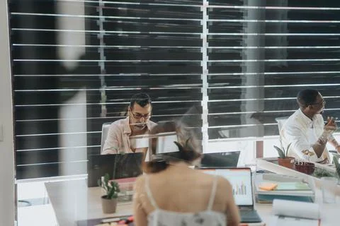 Three business people analyzing data during work time Stock Photos