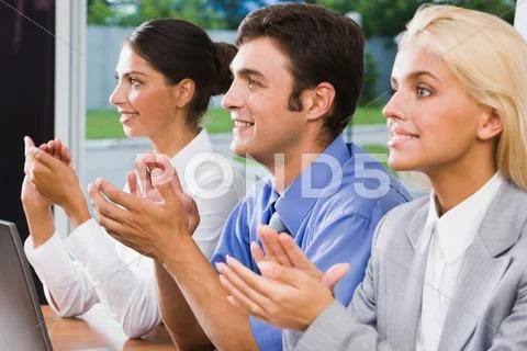 Three business people applauding after finish of speech at a seminar Stock Photos