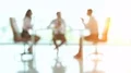 The three business people discuss at the table. no focus 4k or 4k+ Resolution