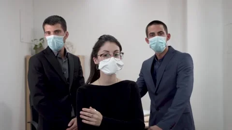 Three business people looking at camera wearing face mask 스톡 동영상 140336599