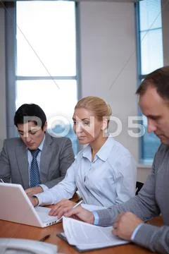Three business people working in office Stock Photos
