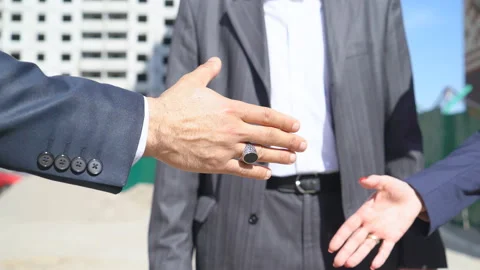 Three businessmen an architect and an engineer are standing at a construction Stock Footage 89427582