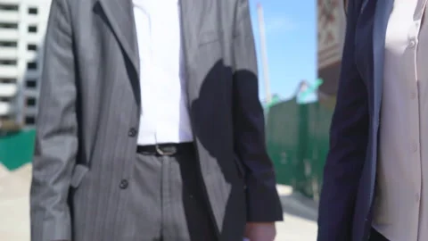 Three businessmen an architect and an engineer are standing at a construction Video stock 89428169