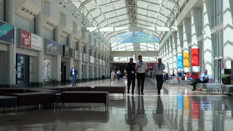 Three businessmen walking inside of NEC Stock Footage 239165375