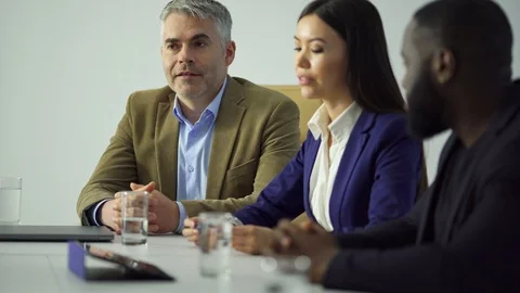 The three businesspeople working at the table Stock Footage 109551799