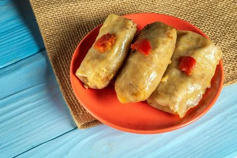 Three cabbage rolls with beef, rice and vegetables on the plate. Stock Photos