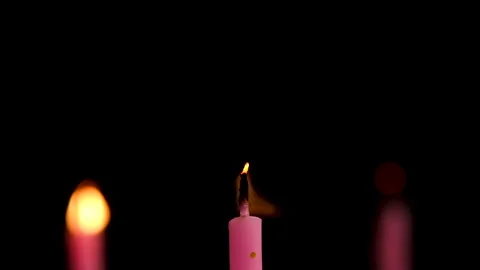 Three cake candles burning on a black background. Stock Footage 306625080
