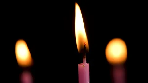 Three cake candles burning on a black background. Stock Footage 311488150
