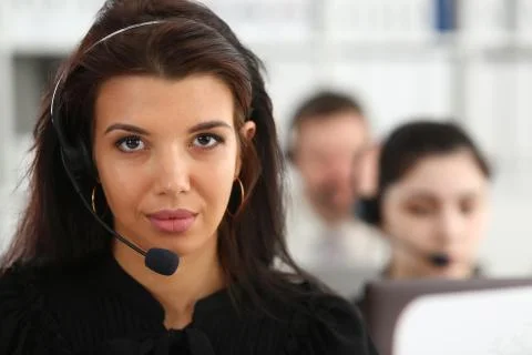 Three call centre service operators at work Stock Photos