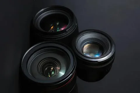 Three camera lenses on black background for photography equipment Stock Photos