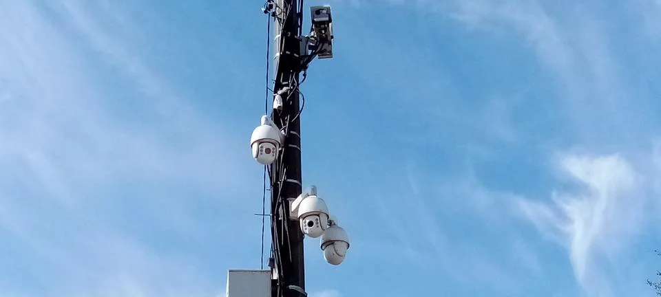 Three cameras on a pole Stock Photos