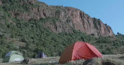 Three camping tents below a beautiful rock mountain 스톡 동영상 108494886