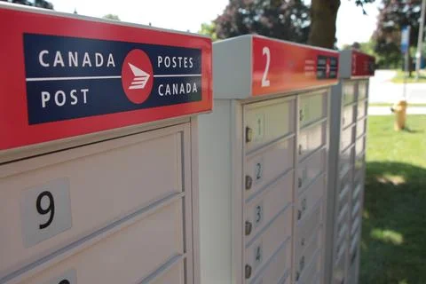 Three canada post community mailboxes with logo top frame left Stock Photos