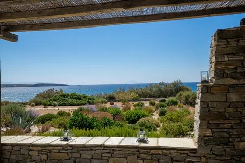 Three candle lantern on an authentic stone wall under a pergola Stock Photos