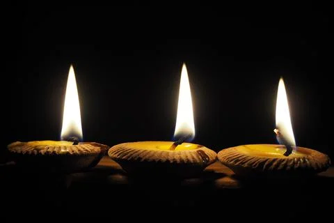 Three candlelight for a black backdrop celebration Stock Photos