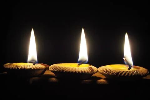 Three candlelight for a black backdrop celebration Stock Photos