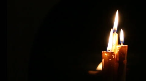 Three candles are burning on the background black. Stock Footage 60217262