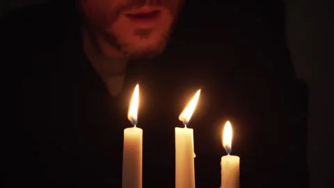 Three candles being blown out by male mouth Stock Footage 250542127