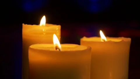 Three Candles blazing in the dark Stock Footage 73925966