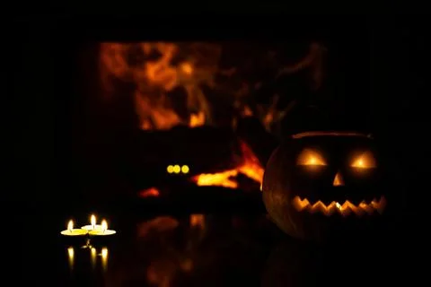 Three candles on a blurry background of flames and pumpkins to celebrate Hall Stock Photos