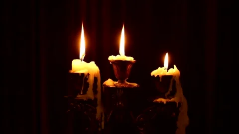 Three candles burn in a candlestick Stock Footage 135126096
