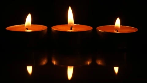 Three candles burning on black background. Zoom in. Close up. Stock-Footage 267549389