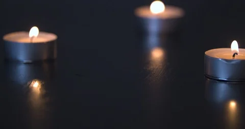 Three Candles Burning on a Black Table Stock Footage 101372559