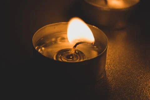 Three candles in the dark, close up Stock Photos