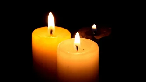 Three candles in the dark finally being blown out Stock Footage 77862262