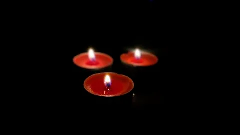 Three Candles in Dark Stock-Fotos