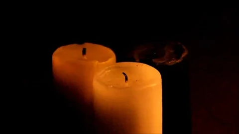 Three candles lighting the darkness Stock Footage 77862467
