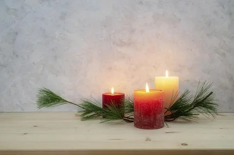 Three candles lit for the third Advent, pine branch as a simple, minimal Foto stock