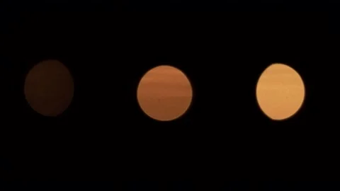 Three candles out of focus waving with nice reflection on water surface in the Stock Footage 133939518