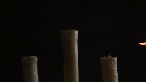 Three candles set fire to the torch Stock Footage 84575406