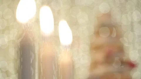 Three candles shift focus to cupcake tower Stock Footage 147917796