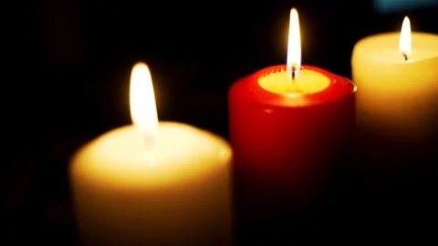 Three candles on table in empty dark room Stock-Footage 74821184