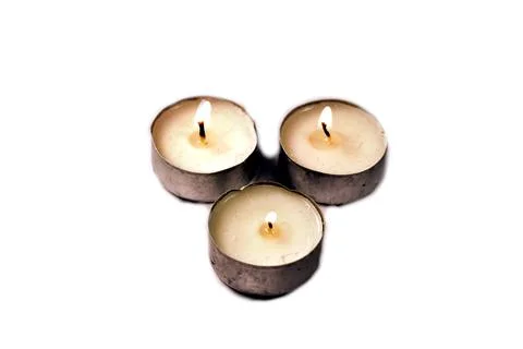 Three candles on a white background Stock Photos