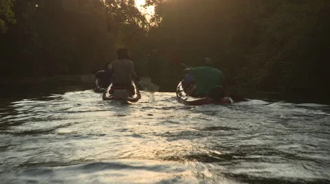 Three canoes on an African river at sunset. Stock Footage 61129366