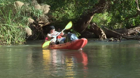 Three canoes rowing along bend in river. Stock Footage 61124141