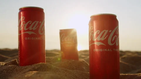 Three cans of Coca Cola on a sandy beach close-up. Stock Footage 205570919