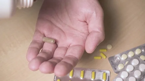 Three capsules fell on the palm of your hand slow mo Stock Footage 83685095