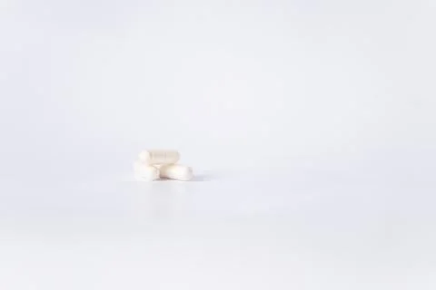 Three capsules with lactobacilli or probiotics on a white background. There i Stock Photos